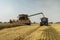 Combine harvester agriculture machine harvesting golden ripe wheat field. Harvester combine harvesting wheat and pouring