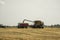 Combine harvester agriculture machine harvesting golden ripe wheat field. Harvester combine harvesting wheat and pouring