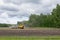 Combine harvester agriculture machine working in field. plows, harrows and cultivates soil for sowing grain