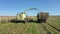 Combine Harvester Collect Ripe Corn At Field And Pour It In Tractor Trailer