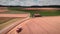 Combine harvester collecting ripe wheat on field. Tractor harvesting ripe cereal crops on yellow agriculture field. Farm heavy mac