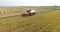 Combine harvester cutting rice on the paddy field