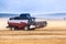 A combine harvester drives through an agricultural field