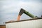 Combine harvester emptying corn into a trailer