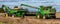 A combine harvester emptying its harvested soybean yield