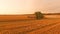 Combine harvester, field and sky.