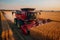 A combine harvester in full action on a lush crop field