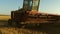 Combine harvester goes on the way to harvest wheat. old tract. Wheat field. a farmer rides an old combine to work