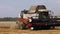 Combine harvester with Harvester for harvesting grain works in the wheat field in slow motion video. The combine goes on