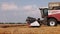 Combine harvester with Harvester for harvesting grain works in the wheat field in slow motion video. The combine goes on