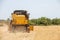 Combine harvester harvesting barley fields