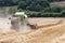 Combine harvester harvesting a crop of wheat