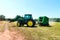 Combine harvester harvesting hay