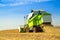 Combine harvester harvesting soybean at field.