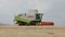 Combine harvester harvests wheat. Shears for wheat. Combined in the field. Food industry concept. Harvester harvesting