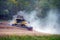 Combine harvester kicks up dust harvesting soy bean crop in farm field