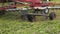 Combine harvester machine attachment collecting cutted grass on field