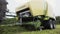 Combine harvester machine carriage collects cutted grass on farm field