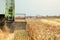 Combine harvester machine harvesting ripe wheat crops