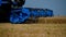 A combine harvester mows ripe wheat in a field. Wheat harvesting