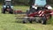 Combine harvester tractor attachment packing cutted grass on field