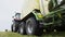 Combine harvester tractor carriage collects cutted grass on field