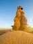 Combine harvester unloading wheat grains into tractor trailer.