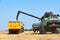 Combine harvester unloading wheat into a trailer