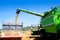 Combine harvester unloading wheat in truck