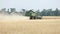 Combine harvester on the wheat field, Green harvester working on the field, view on the combines and tractors working on