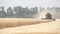 Combine harvester on the wheat field, Green harvester working on the field, view on the combines and tractors working on