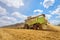 A combine harvester at work on a field.