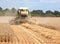 Combine harvester working in field