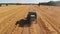 Combine harvester working on the field. Aerial slow motion