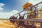 Combine harvester working on large wheat field on a sunny day