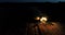 Combine harvester working on a wheat crop at night. Aerial view