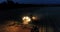 Combine harvester working on a wheat crop at night. Aerial view.