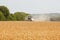 Combine harvester working in a wide wheat field