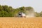 Combine harvester working in a wide wheat field