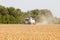 Combine harvester working in a wide wheat field