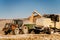 Combine harvester works in corn fields, unloading corn into tractor trailer