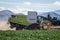 A Combine harvester works on a farm in summertime