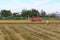 Combine harvester works in a rice field during the first rice harvest of 2021 in Hoi An, Vietnam