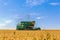 Combine harvester works on a wheat