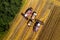 Combine harvesters pour grain into the truck top view