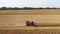 Combine harvesting corn on the field aerial view.