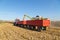 Combine harvesting corn and unloading grains in to tractor trailer