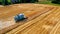 Combine harvesting golden ripe wheat field. Harvester working in field, aerial view