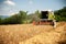 Combine harvesting grain on a hot summer afternoon - agricultur