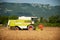 Combine harvesting grain on a hot summer afternoon - agricultur